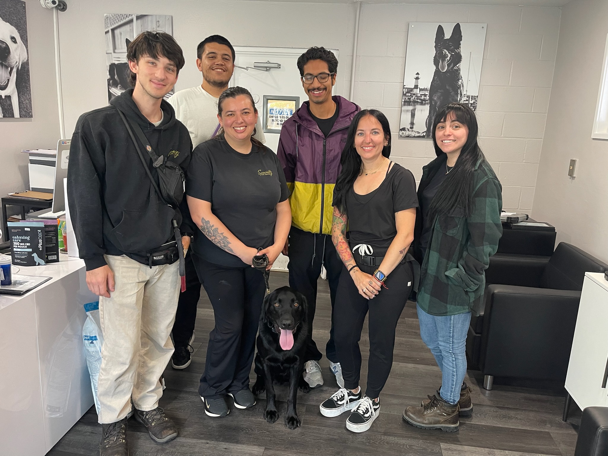 Service dog trainers posing with a service dog