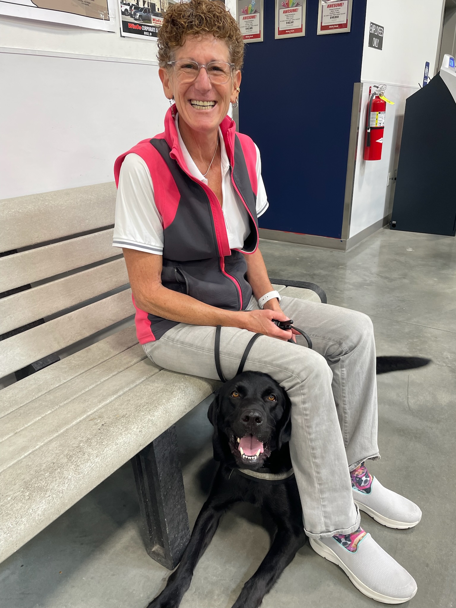 Service dog and happy owner sitting on a bench